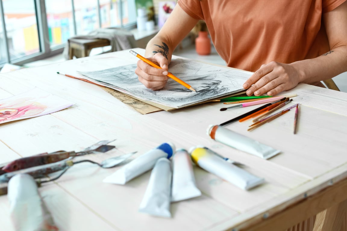 Young Female Artist Drawing in Workshop